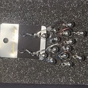 Silver chandelier earrings with balls.